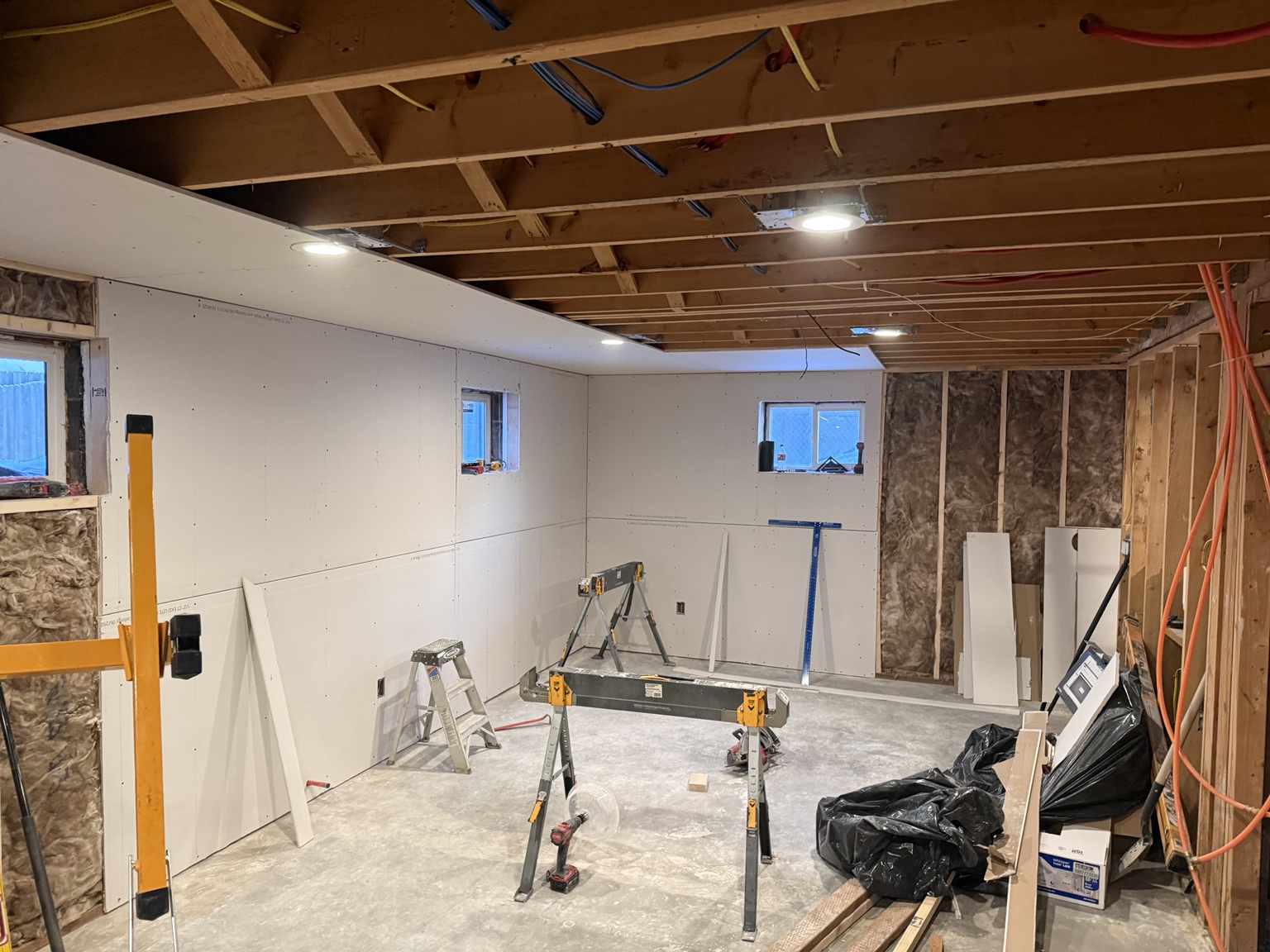 Insulated basement with new drywall and recessed lighting during renovation