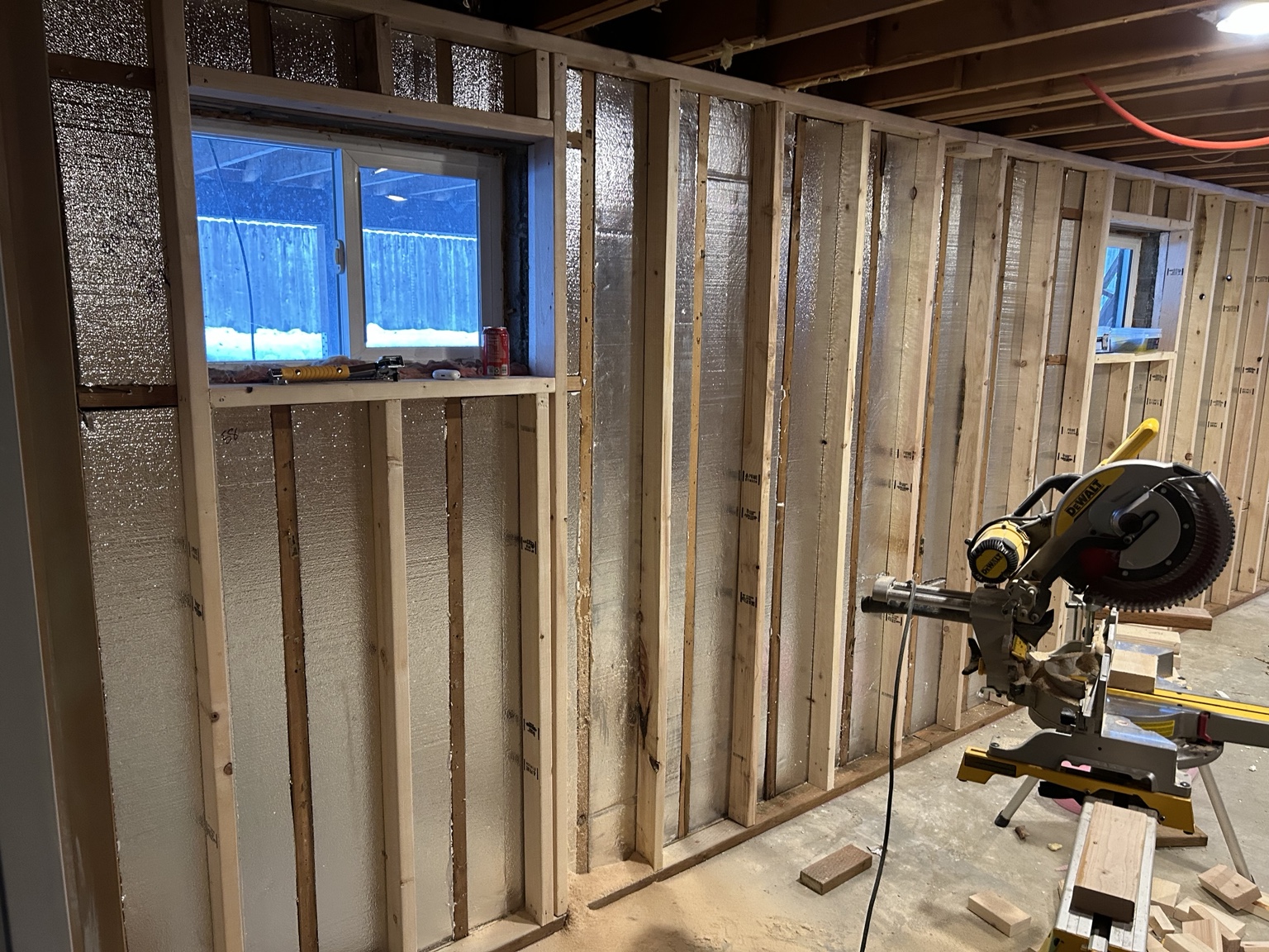 Basement wall framing and reflective insulation during reconstruction
